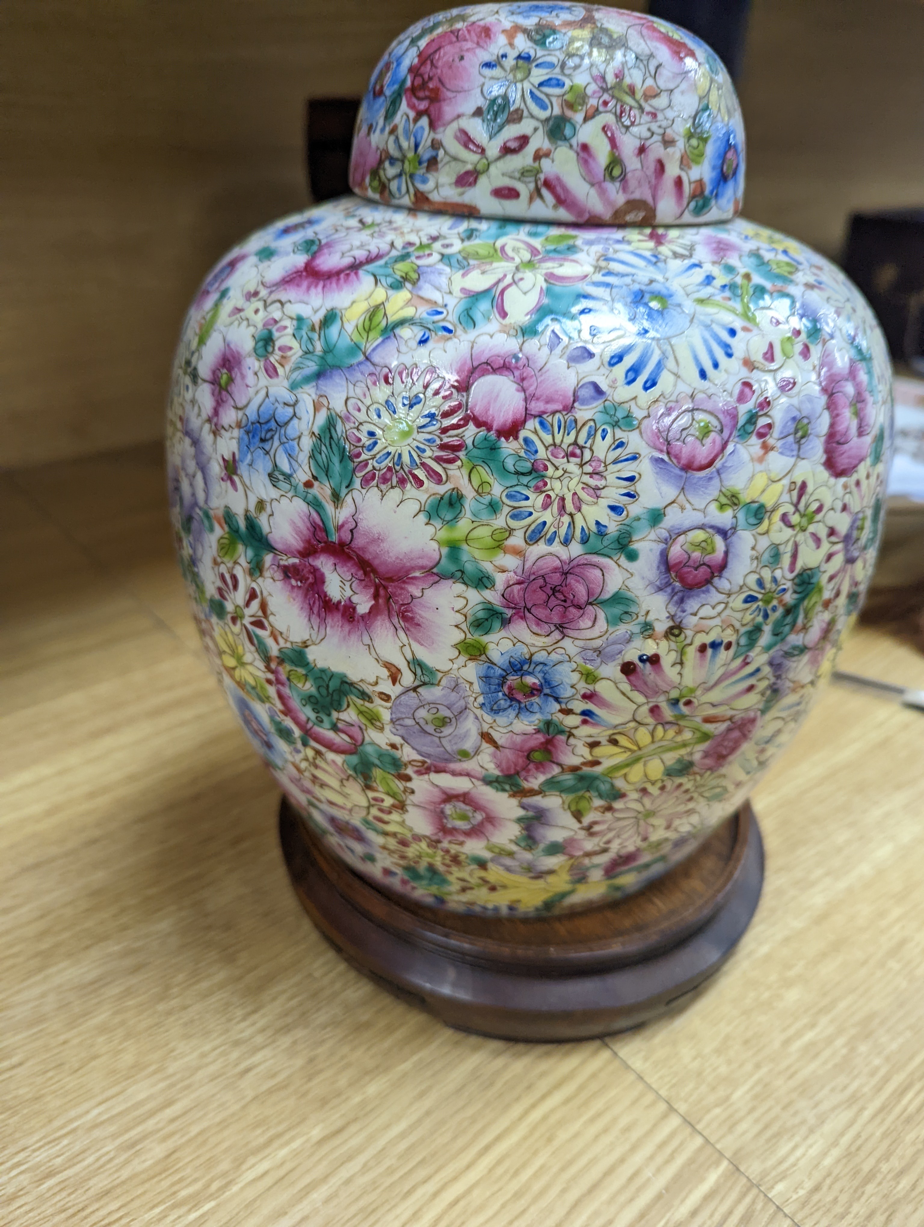 A Chinese thousand flower famille rose jar and cover, early 20th century, wood stand 28cm